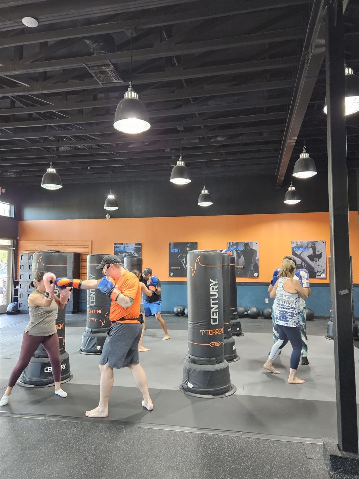 A Vibes Lifestyle coach holding a target up for a member mid-punch during class